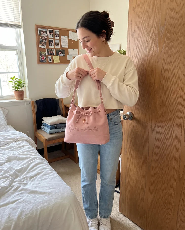 Woman enjoying her new blush pink faith-inspired handbag