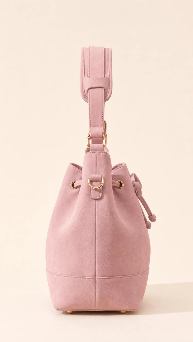 Side view of the blush pink bag and its hardware