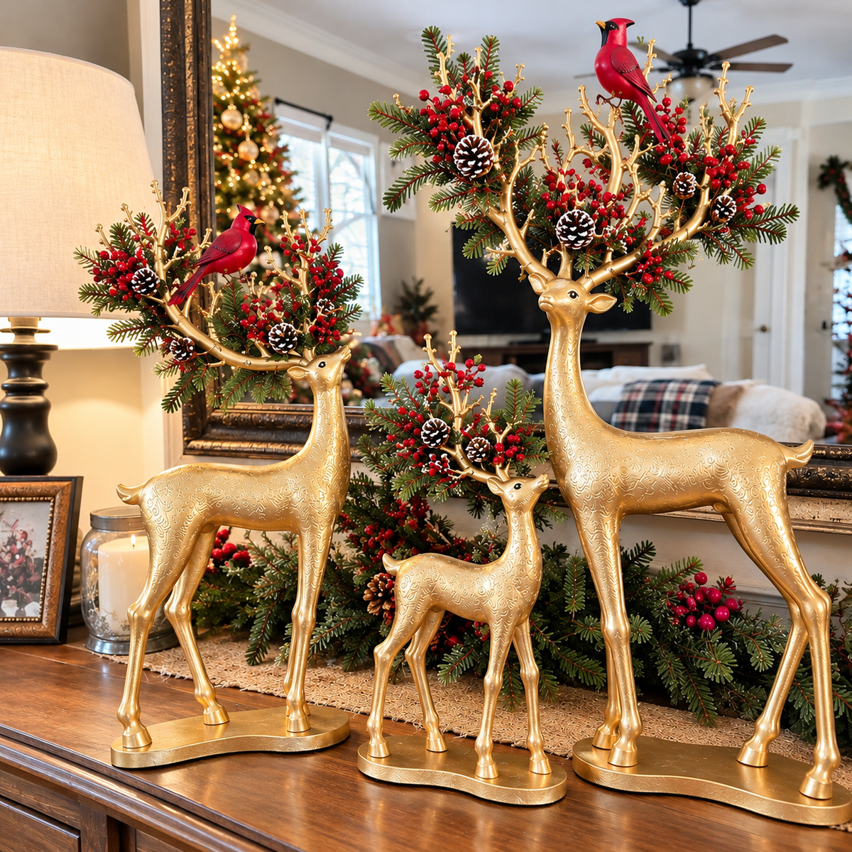 Three golden Christmas deer with glowing antlers, red cardinals and evergreen details displayed by a round mirror