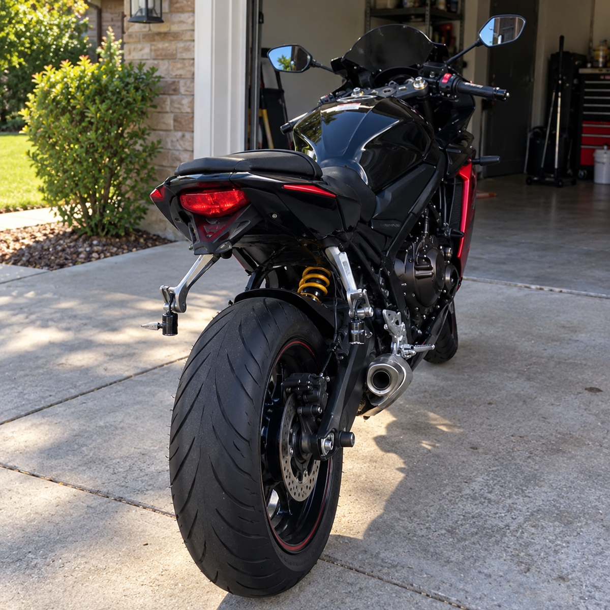 Daytime rear three-quarter view of a sport motorcycle showing compact projector hardware