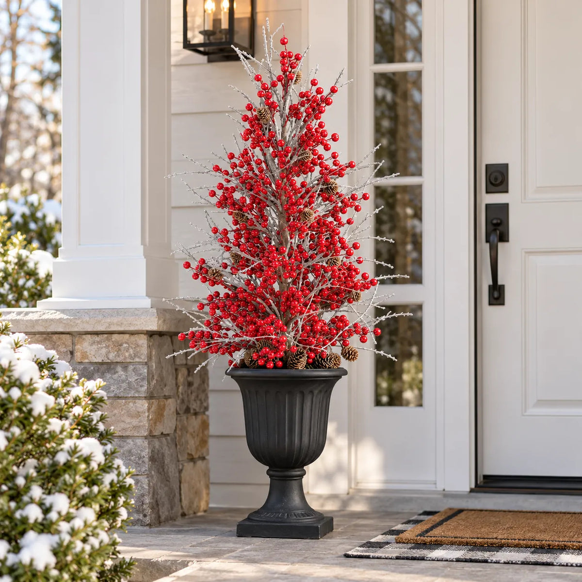 Single frosted red berry Christmas arrangement displayed in a planter