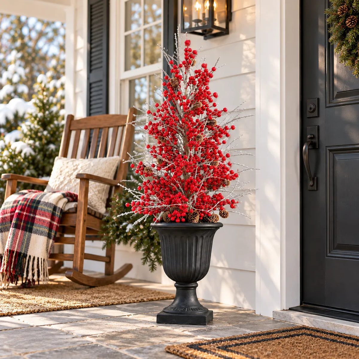 Red berry holiday arrangement beside a porch rocking chair