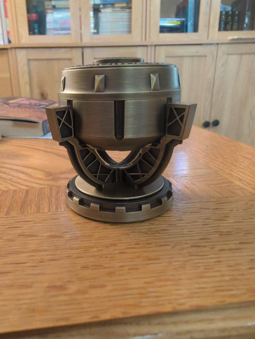 Actual bronze-tone mechanical fantasy dice holder on a desk