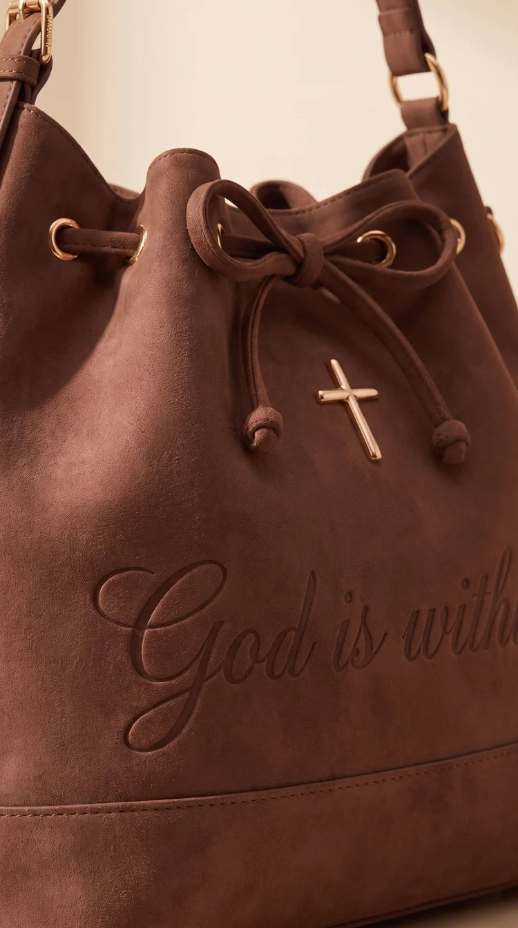 Close-up of the vintage brown suede-look bag texture and gold-tone cross