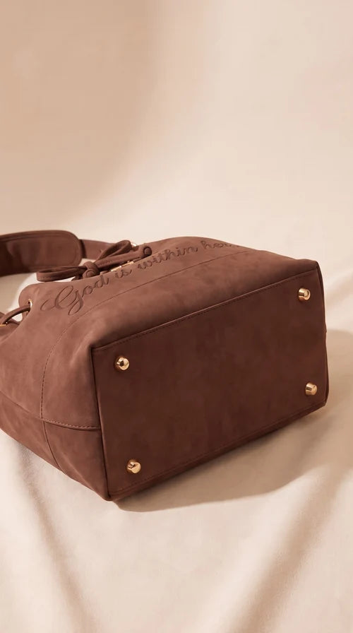 Base of the handbag showing four gold-tone feet