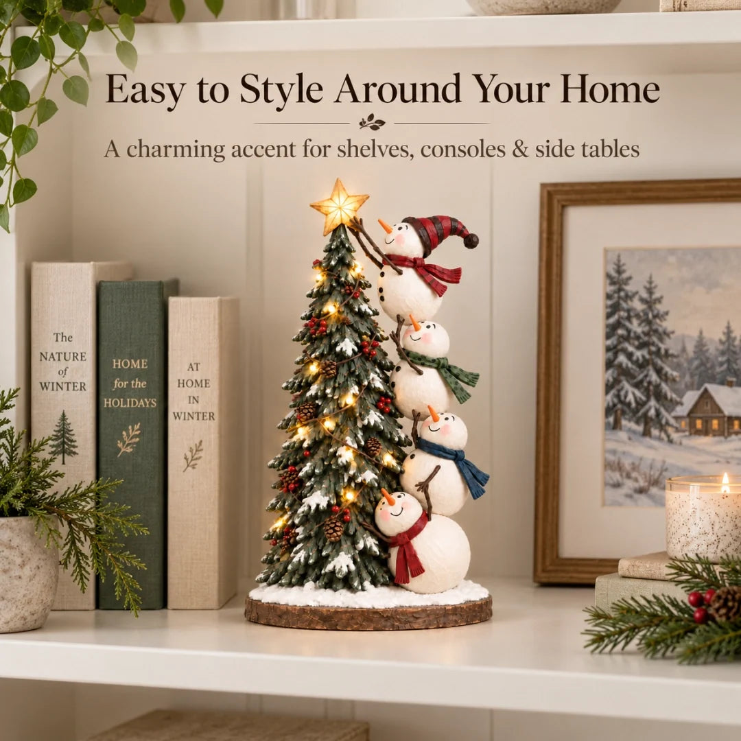 Snowmen Christmas tree figurine styled on a shelf with books and winter artwork