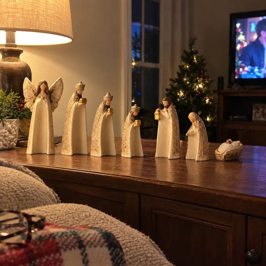 Ivory and gold Nativity figures displayed in a warm family living room at Christmas