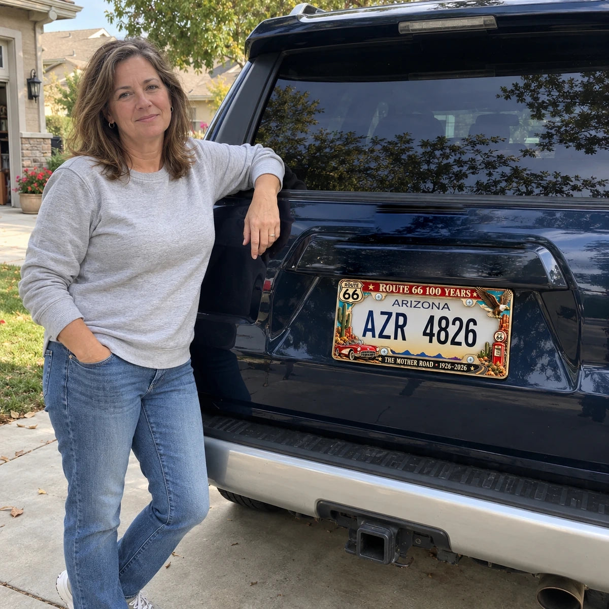 Woman by Toyota 4Runner with Route 66 Centennial frame