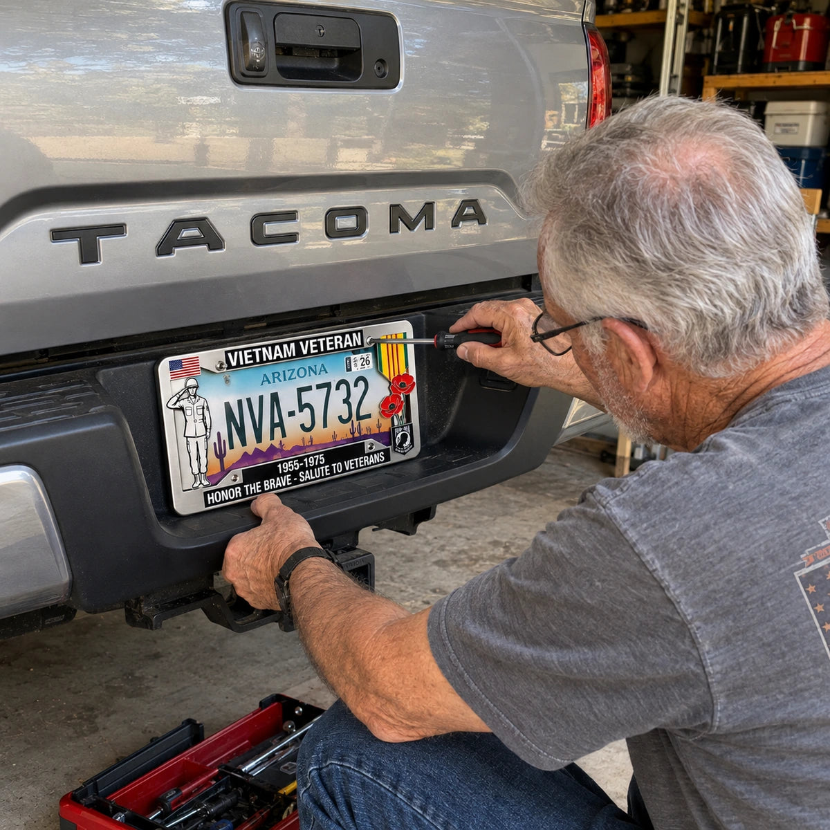 Man securing Vietnam Veteran frame to a pickup